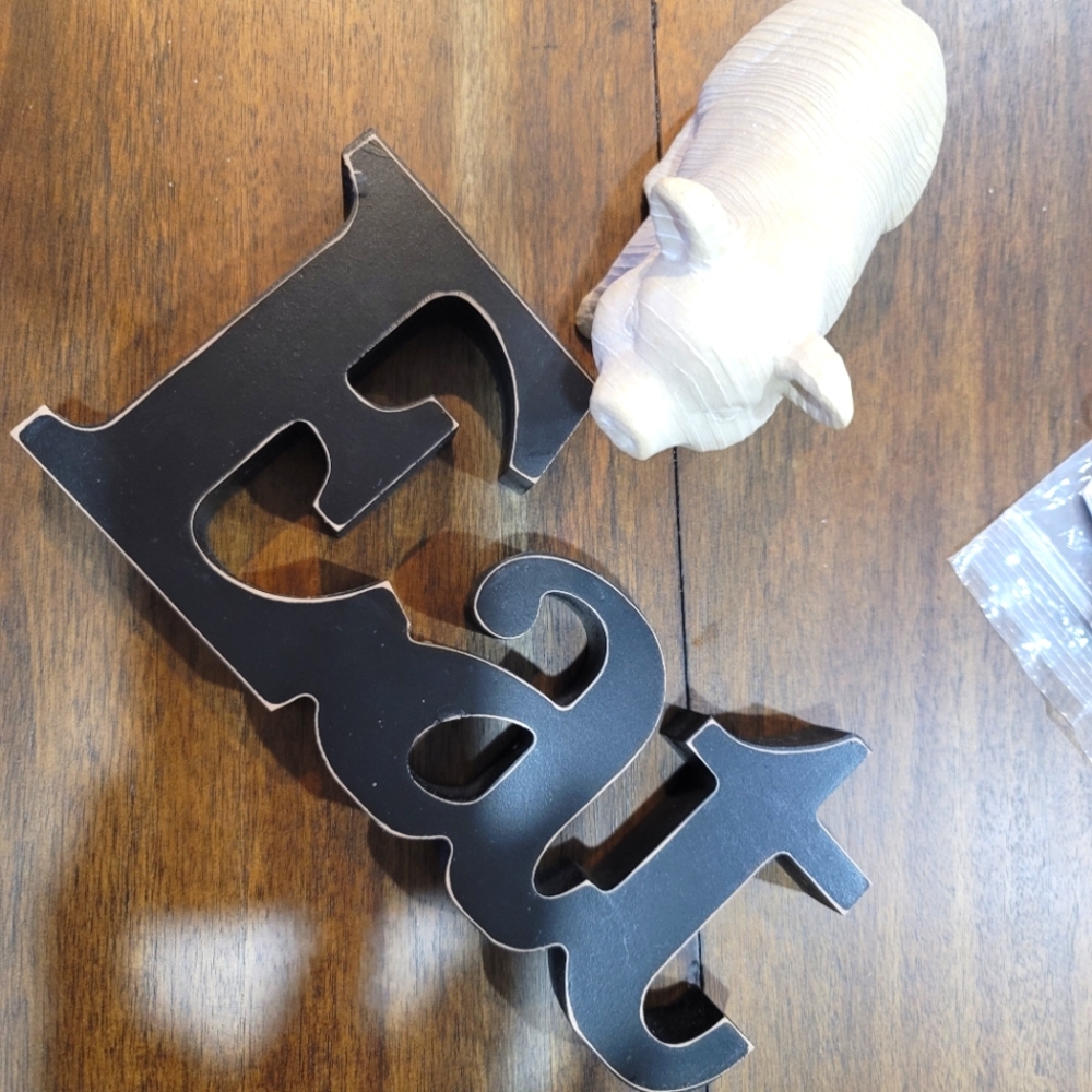 Ceramic pig and Eat sign